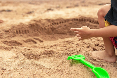 Boy playing with toy on sand