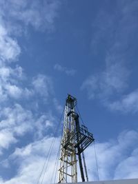 Low angle view of crane against blue sky