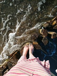 Low section of woman standing in water