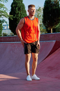 Portrait of young man exercising on road