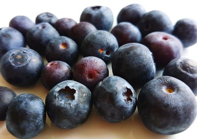 Close-up of blueberries against white background