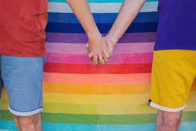 High angle view of men standing against multi colored umbrella