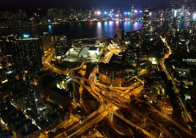 High angle view of illuminated buildings in city at night, hong kong