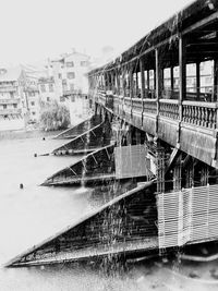 Train on bridge over river against clear sky