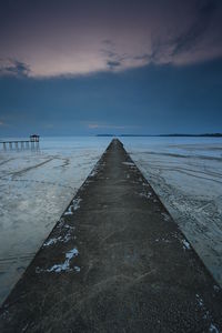 Scenic view of beach against sky during sunset