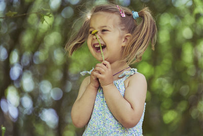 Young woman blowing bubbles in park