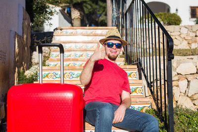 Man wearing sunglasses sitting on seat