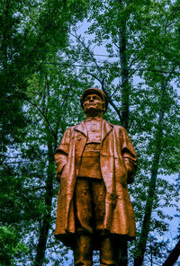 Low angle view of statue against trees