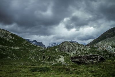 Scenic view of mountains against cloudy sky