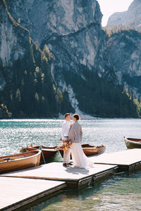 Rear view of couple sitting on mountain