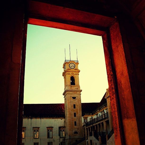 architecture, built structure, building exterior, low angle view, window, clear sky, place of worship, religion, church, sky, spirituality, city, building, clock tower, no people, history, high section, clock, outdoors