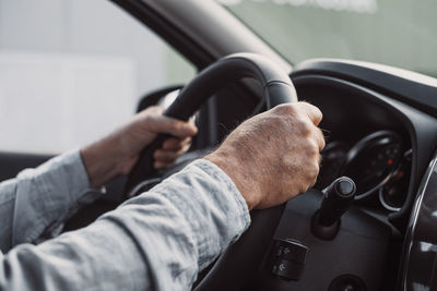 Low section of man driving car
