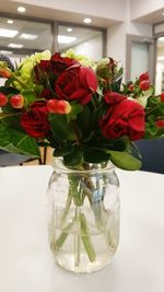 Close-up of roses in vase on table