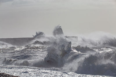 Water splashing in sea against sky