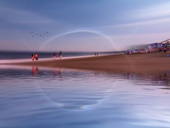 People walking on misquamicut beach against sky