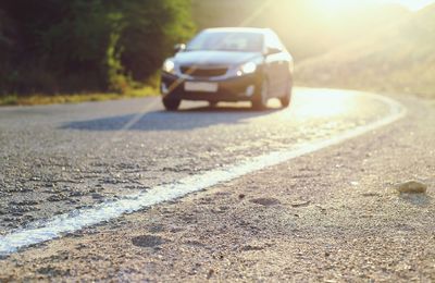 Close-up of car parked on road