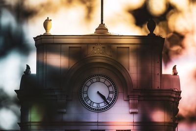 Low angle view of clock tower against building