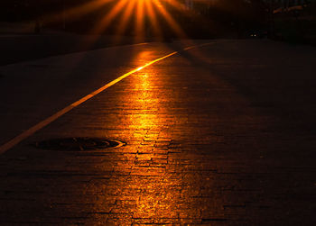 View of illuminated road at night