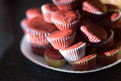 Heap of chocolate cupcakes on table