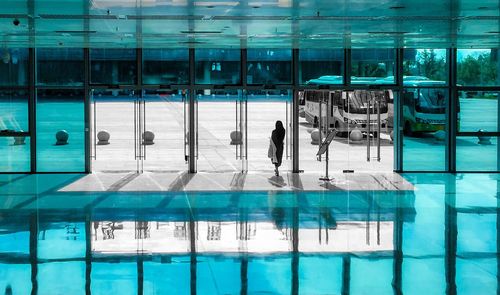 Man standing by swimming pool