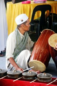 Mature man playing drum