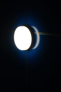 Low angle view of illuminated light against sky at night