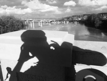 Silhouette of woman against cloudy sky