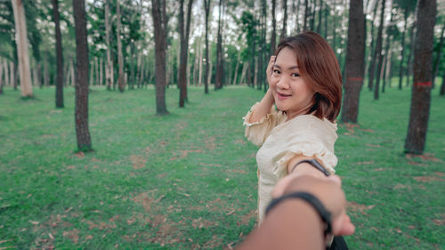 Smiling young woman in forest