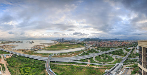 High angle view of road amidst cityscape against sky
