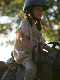 Cute girl sitting on horse