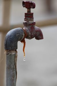 Close-up of water faucet against blurred background