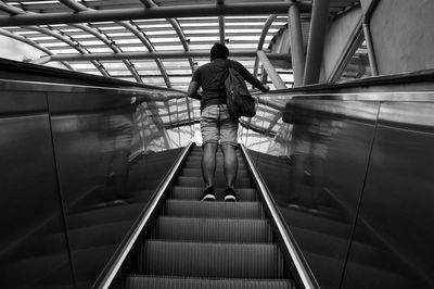 Rear view of man on escalator