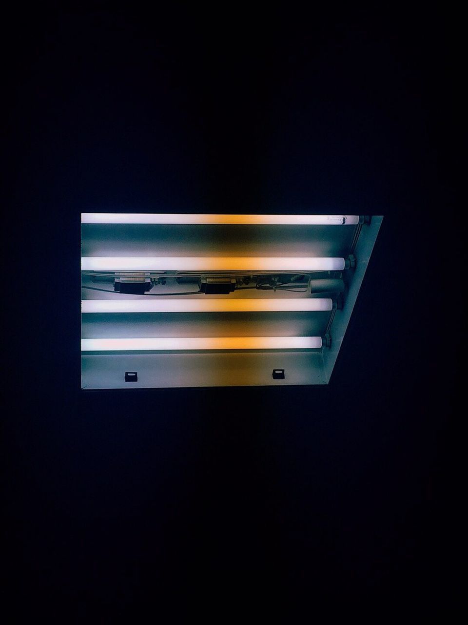 LOW ANGLE VIEW OF ILLUMINATED LIGHT FIXTURE ON CEILING