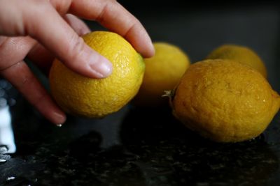 Close-up of hand holding orange