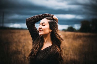 Young woman standing on field