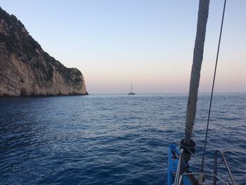 Sailboat sailing in sea against clear sky