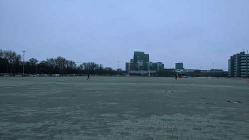 Buildings in city against clear sky during winter