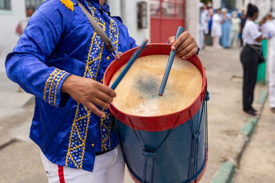 Members of a marujada, play percussion instruments during a parade at the chegancas meeting 