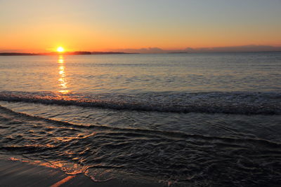 Scenic view of sea against romantic sky at sunset