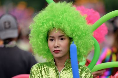 Young woman wearing green wig