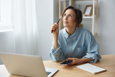 Young businesswoman working at desk in office