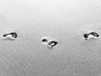 Close-up of footprints on sand