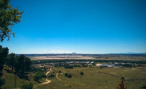 Scenic view of landscape against blue sky