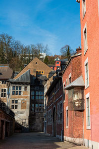 Buildings in town against blue sky