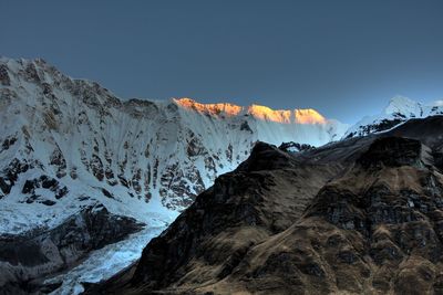 Scenic view of snowcapped mountains against clear sky