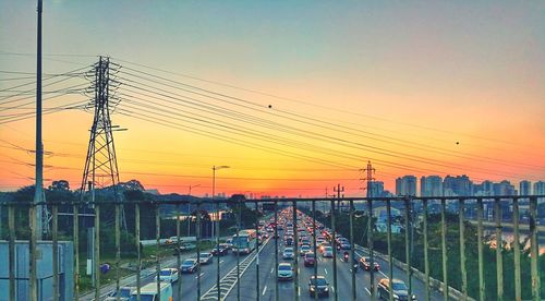 Panoramic view of electricity pylons against clear sky during sunset