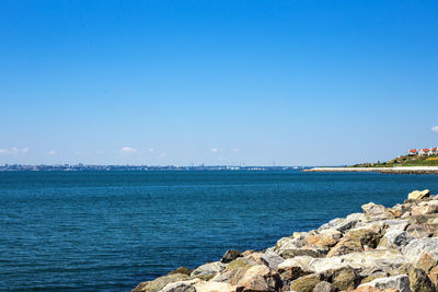 White stones beach,rocky beach with a blue sky and clear water by the ocean