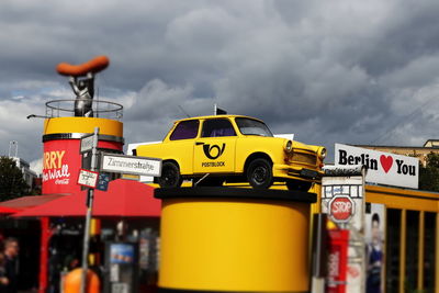 Close-up of yellow road sign against sky