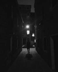 Full length of people walking in illuminated alley