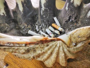 High angle view of cigarette smoking on table